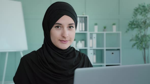 Muslim Businesswoman Freelancer in Black Hijab Working Typing on Laptop Using Computer Service for