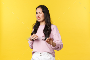 oss stay away from me. Disgusted picky and arrogant asian woman gesturing and step back with aversion, rejecting offer, refusing, yellow background.