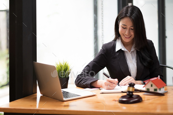 tract papers with brass scale on wooden desk in office. Law, legal services, advice, Justice and real estate concept