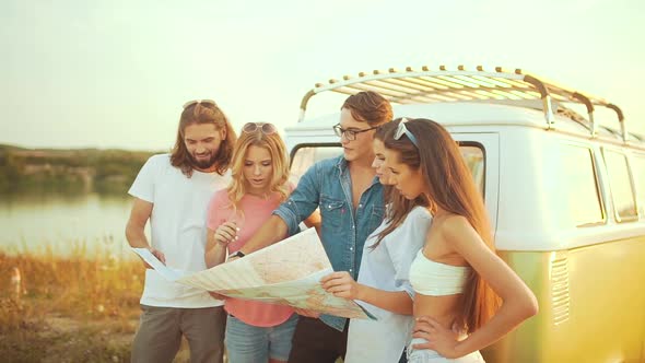 Young People With Map Near Car In Summer. Group Of Happy Smiling Friends.