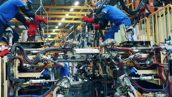 Car Body Workers Welding Car Body at a Car Manufacturing Facility.