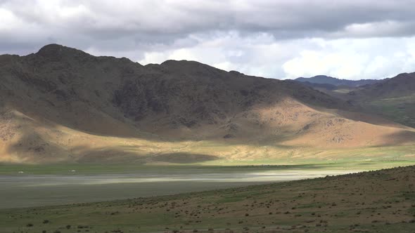 Asian Yurts in Green Plain Beside The Treeless Hill