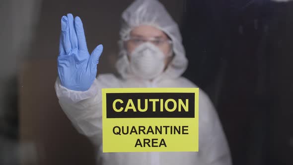 Woman in Protective Suit in Quarantine Zone Signed Stop. Coronovirus and Isolation Concept