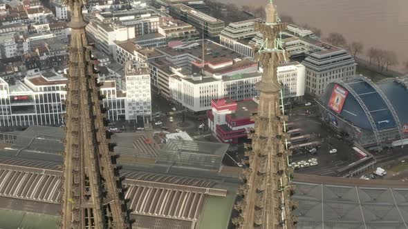 AERIAL: Close Up Overhead Circle Around Cologne Cathedral Brown Towers in Beautiful Sunlight 