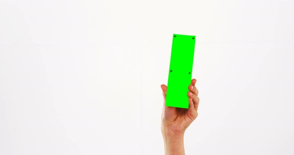 Hand of a woman holding green pla card