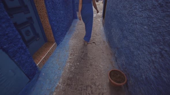 Woman In Blue Dress Walking In Kasbah Of The Udayas