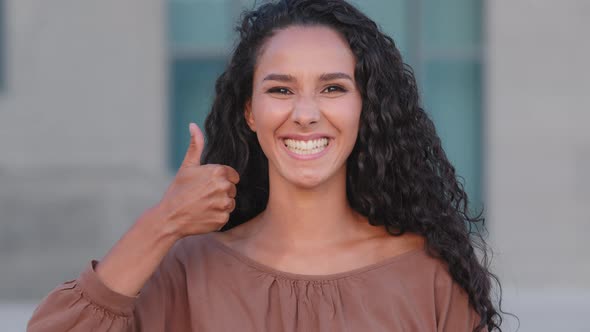 Enthusiastic Happy Successful Brunette Girl Hispanic Curly Woman Standing Outdoors City Building