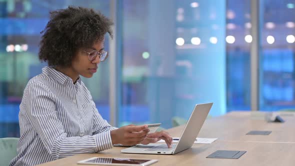 Successful Online Payment By African Businesswoman on Laptop in Office