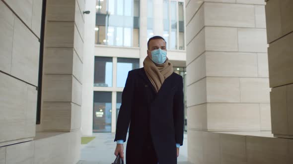 Responsible Businessman Wearing Protective Mask Walking on City Street