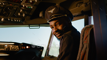 Portrait of male copilot pressing power switch buttons