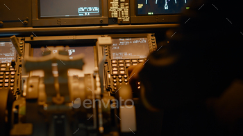 Male copilot inserting flight coordinates to arrive at destination