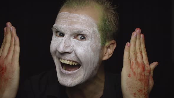 Clown Halloween Man Portrait. Close-up of an Evil Clowns Face. White Face Makeup