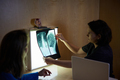 Doctor with patient looking at an X-ray of the spine - PhotoDune Item for Sale