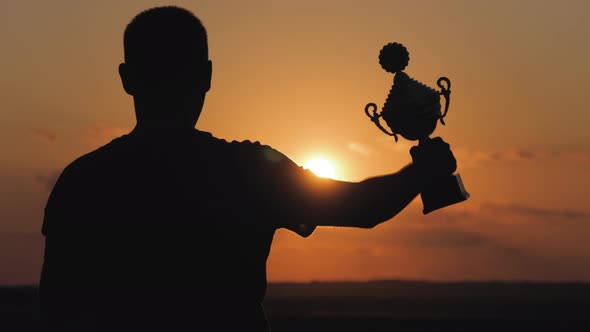 Silhouette Best Man Winner Award Victory Trophy for Professional Champion Challenge Holding Trophy