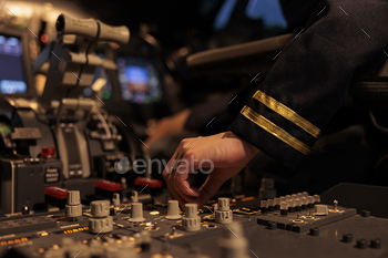 Woman copilot using control panel command on dashboard