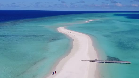 Aerial travel of lagoon beach by blue water with sand background