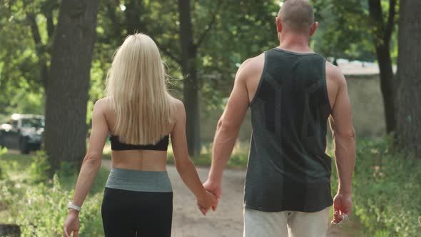 Couple of Athletes Go After Training in Park