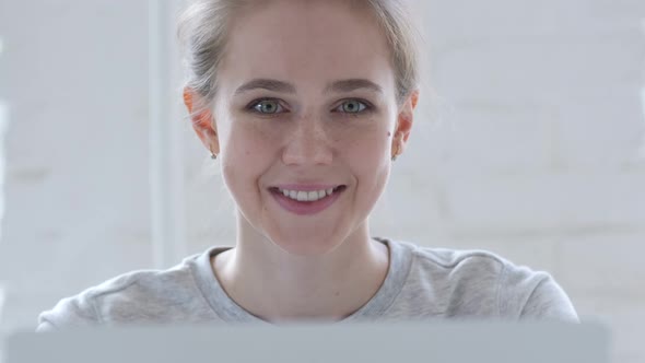 Yes Young Woman Accepting Offer By Shaking Head at Work