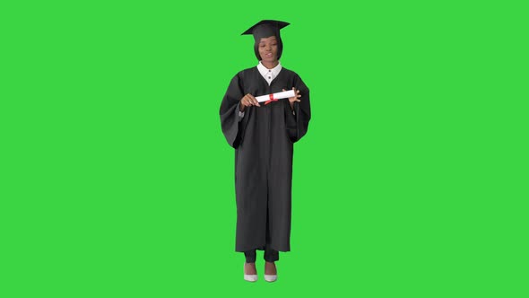 African American Female Graduate Holding Diploma and Giving Speech on a Green Screen, Chroma Key.