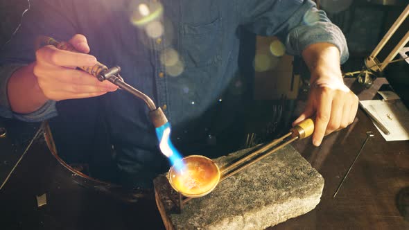 Jewelry Is Getting Heated with the Burner in Craftsman's Hands