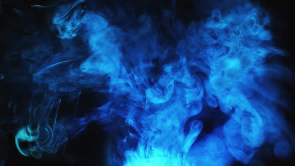 Whimsical movement of colored puffs of smoke against a dark background.