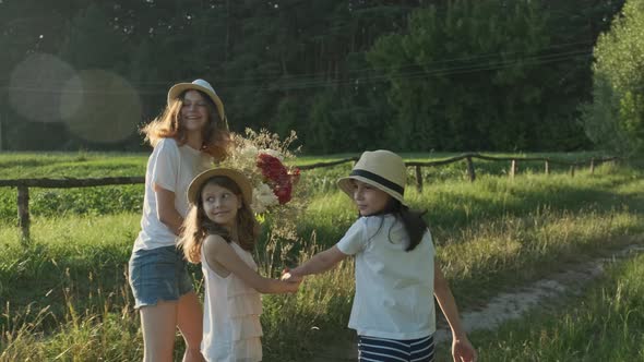 Children Three Girls in Hats Holding Hands Running Back Along Rural Country Road