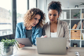 Two business women working together with digital tablet and laptop in the modern startup office. - PhotoDune Item for Sale