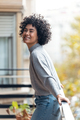 Beautiful woman posing while looking at camera standing in the balcony at home. - PhotoDune Item for Sale