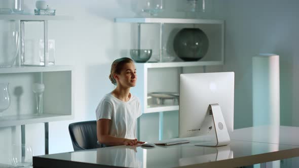 Young Businesswoman Finishing Video Call at Home Office