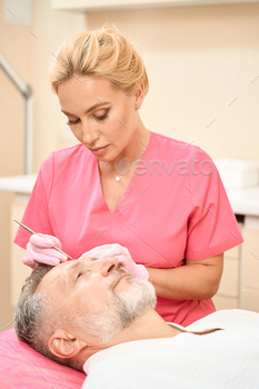 face of male patient in beauty salon. Cropped photo