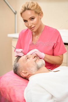 e of male patient in beauty salon. Cropped photo