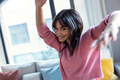 Pretty young woman listening to music while dancing in the living room at home. - PhotoDune Item for Sale