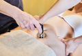 The osteopath applies a radiofrequency treatment to the abdomen. - PhotoDune Item for Sale