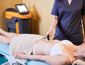 Osteopath applying a radiofrequency treatment to the pelvic floor after childbirth. - PhotoDune Item for Sale