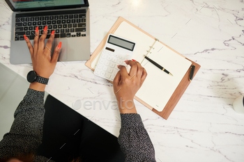 oing calculations and taking notes in planner