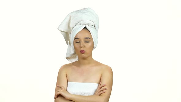 Girl in White Towel on Her Head Chews Closing Her Eyes From Pleasure Isolated on White Background
