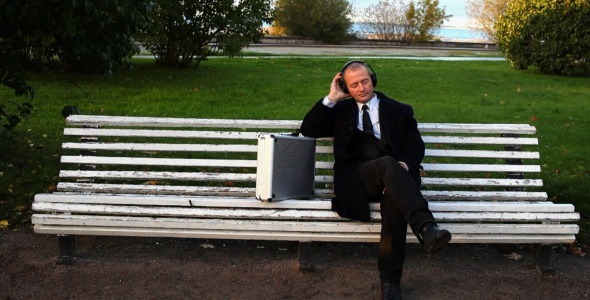 Senior Businessman Enjoying Music Outside