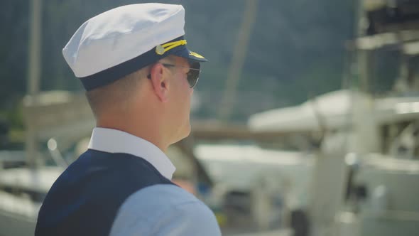 Sailor captain strolling in marina