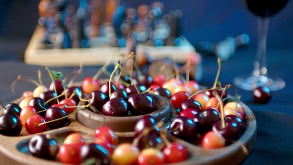 Close Up of Compartmental Dish with Different Varieties of Sweet Cherries on Table