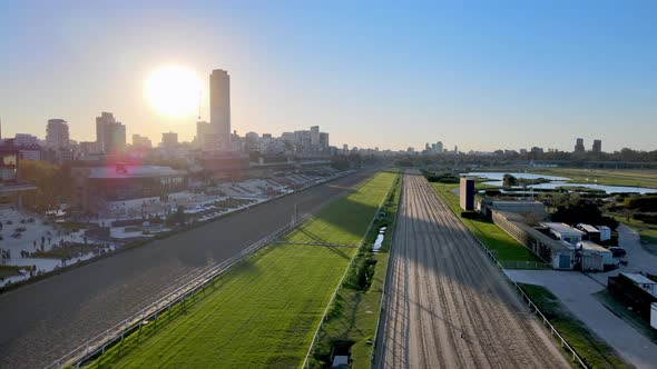 Forward aerial of empty horse racing track at sunset in Buenos Aires