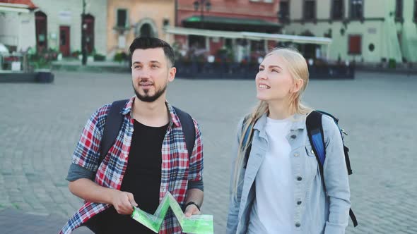 Man and Woman with Map Looking for New Historical Place in City Center