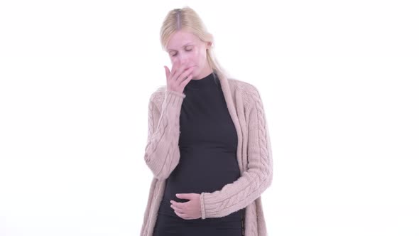 Stressed Young Blonde Pregnant Woman Thinking and Looking Down