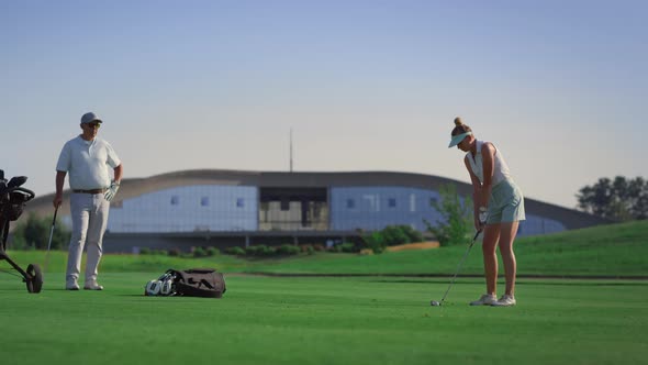 Golf Team Players Hitting Ball at Golfing Country Club