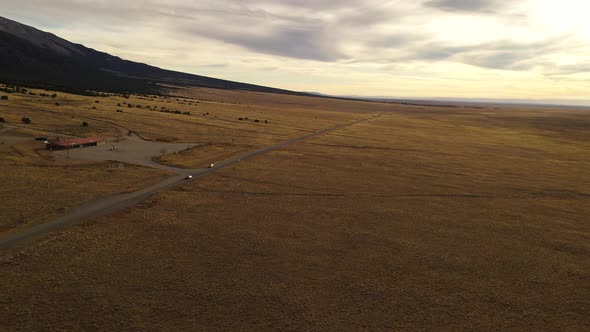 Cars Driving On Mountain Valley Road Aerial Pan Shot 4K