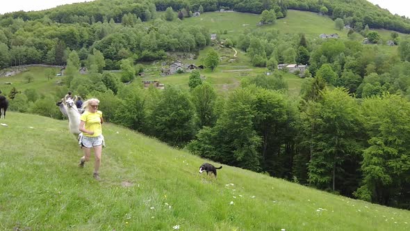 Woman Running with Alpaca on Comino Mount