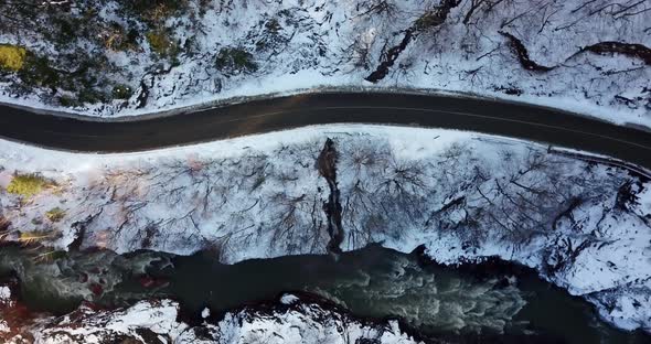 Aerial View of a Mountain Road Covered in Snow