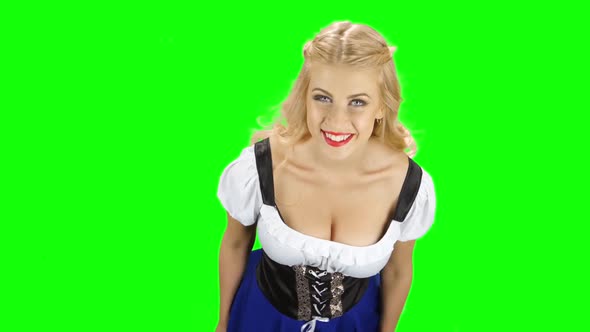 Woman in Bavarian National Costume Shows the Thumb. Green Screen