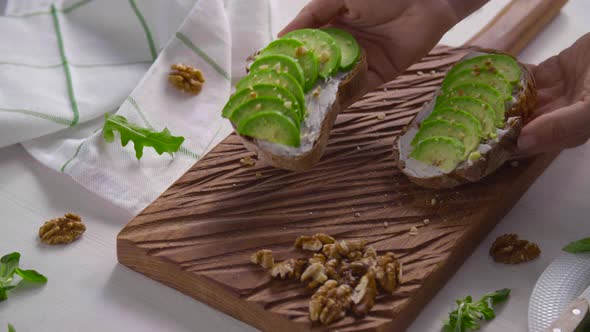 Healthy Eating Concept. Toast with Avocado Cream on the White Wooden Board