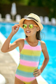 Girl touching her hat standing near pool - PhotoDune Item for Sale