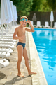 Boy standing near pool gesturing ok - PhotoDune Item for Sale
